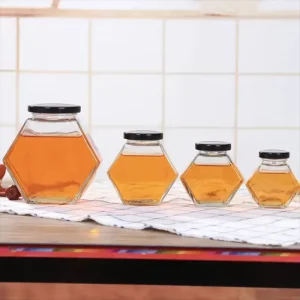 Customise Elegant Unique Luxury Hexagon Glass Honey Jar with Screw Cap Hot Stamped Carton Packed